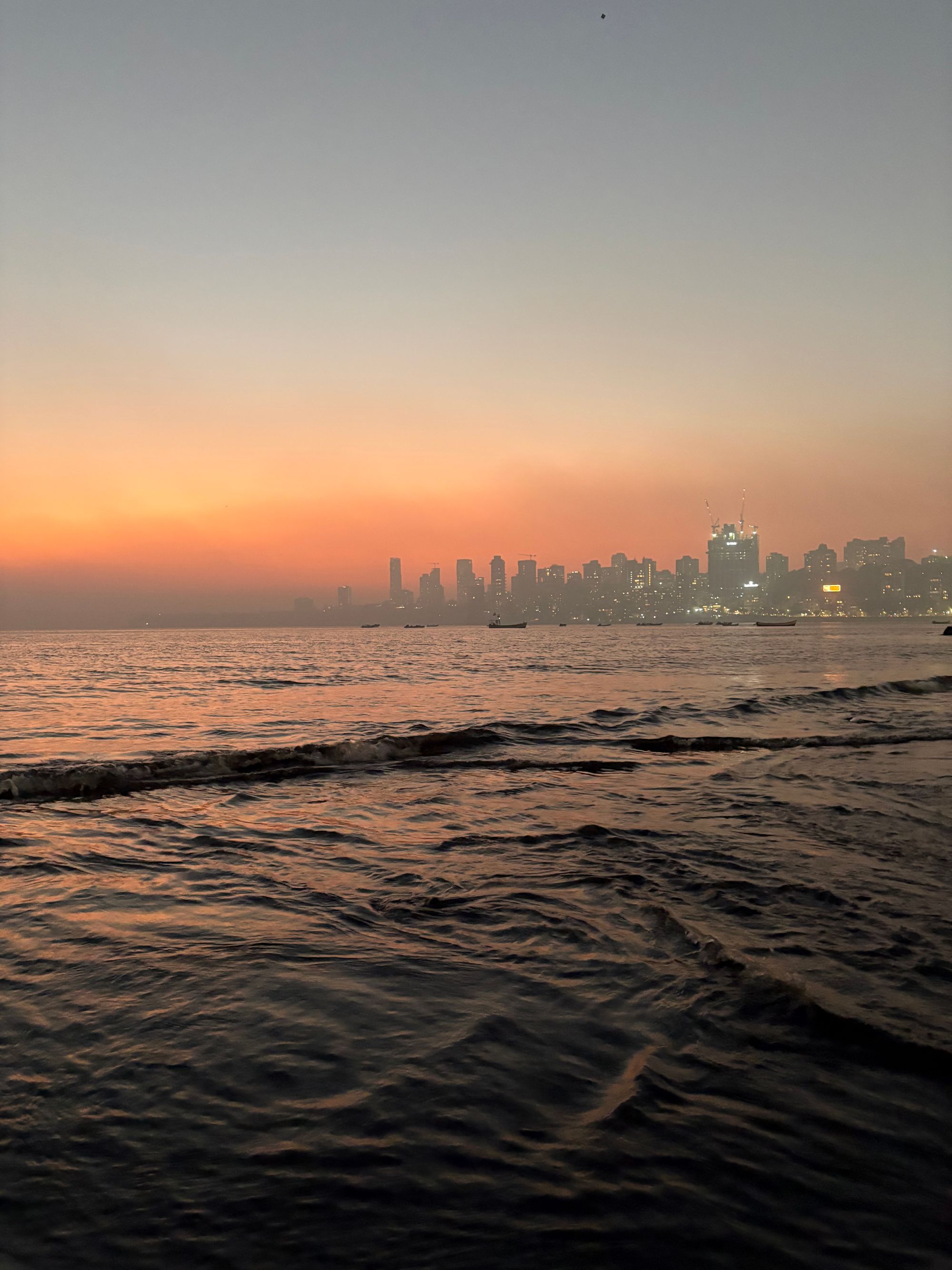 Mumbai skyline across the Arabian Sea at sunset
