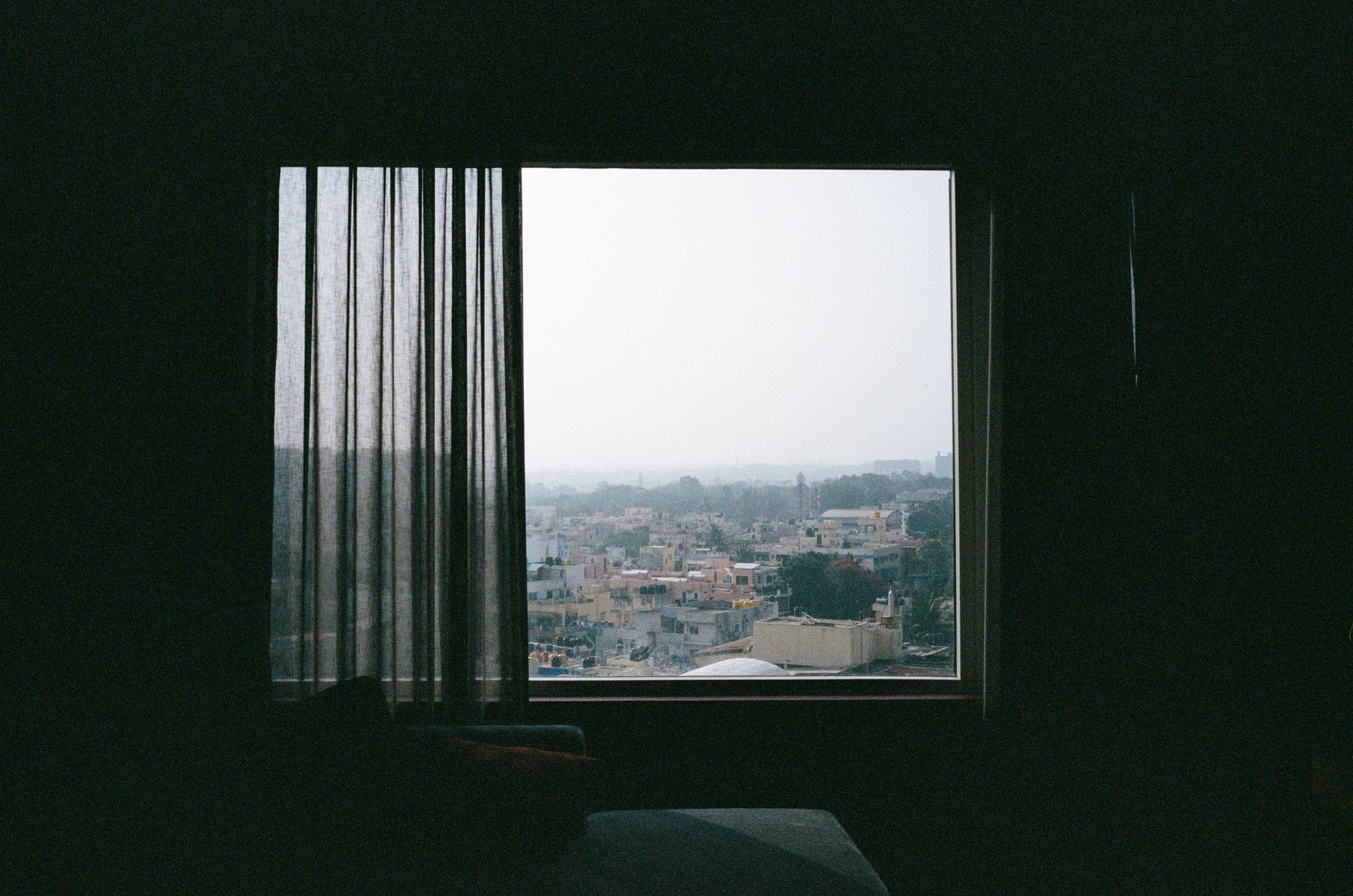 View from a quiet interior across a city, evoking an atmosphere of focused work